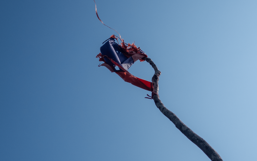 A Flag in tatters at the top of the pha boom hike in muang ngoi, laos