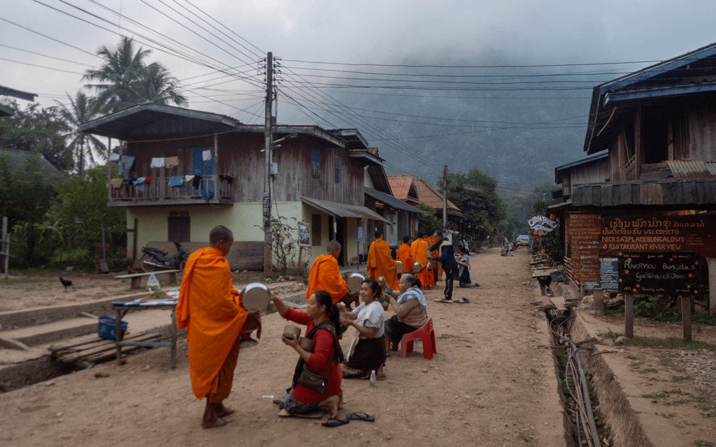 Offerings from the locals to the monks, walking in Muang ngoi, loas