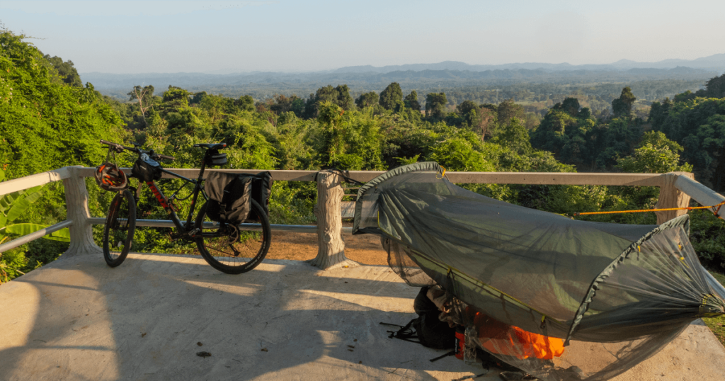 Bicycle and hammock set up in the mountains in Thailand, during my bikepacking trip across Southeast Asia.